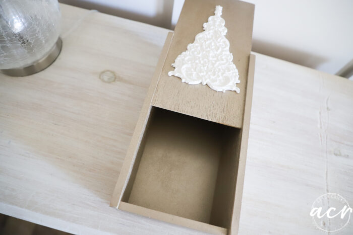 white tree on top of gold box sliding open