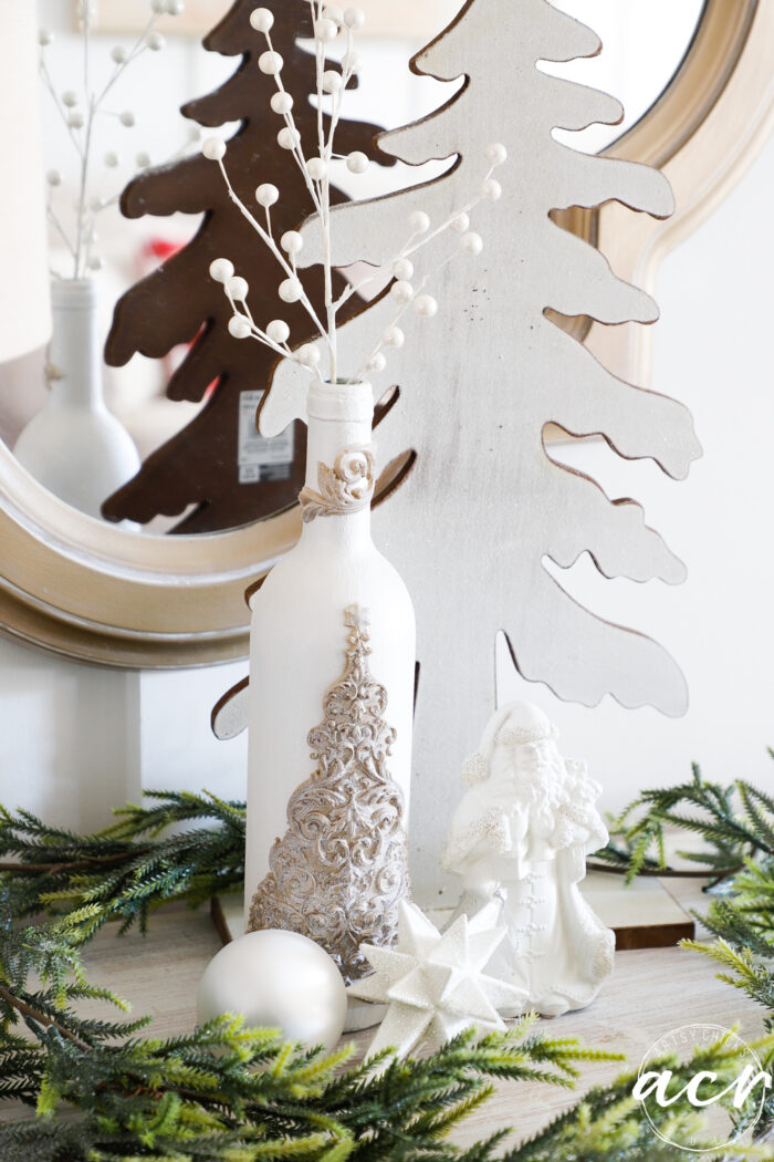 white centerpiece items, tree, santa, bottle and ornaments