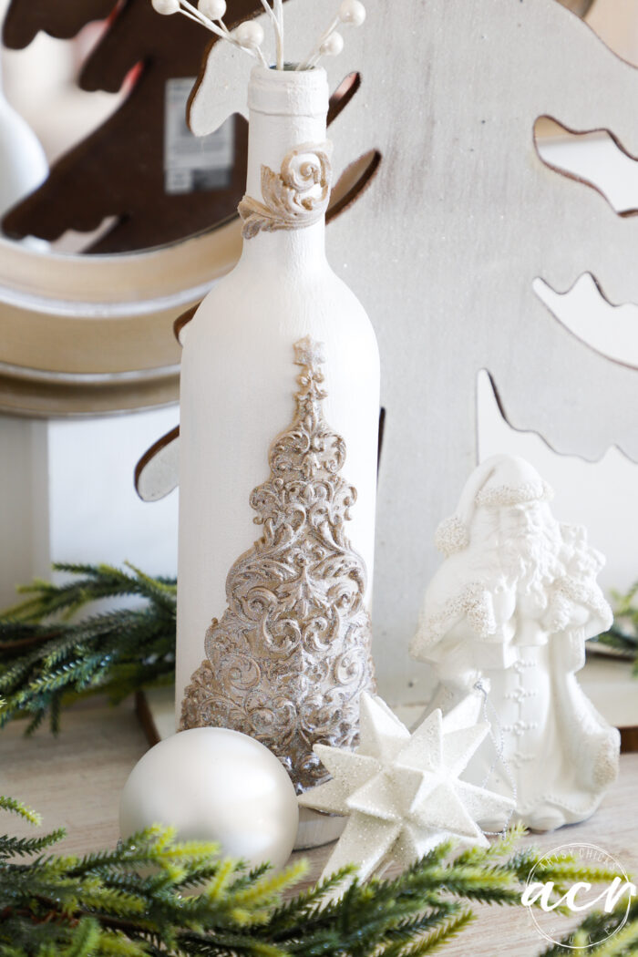 white bottle with gold tree and santa