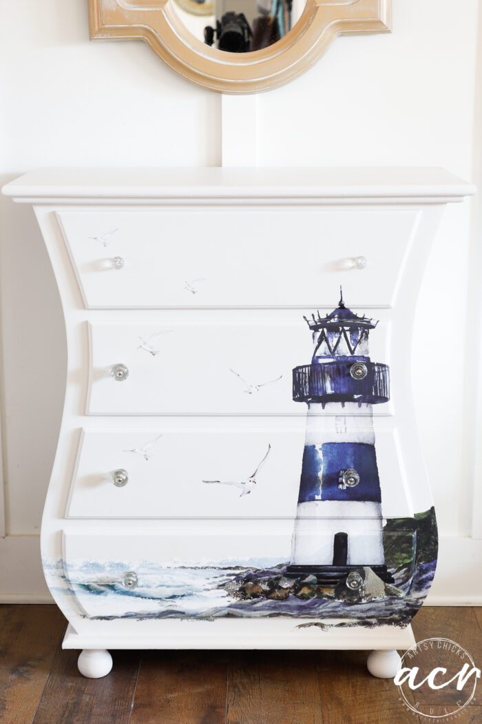 small white chest with blue and white lighthouse transfer on front