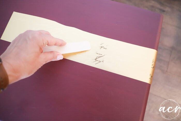 rubbing gold transfer with wood stick