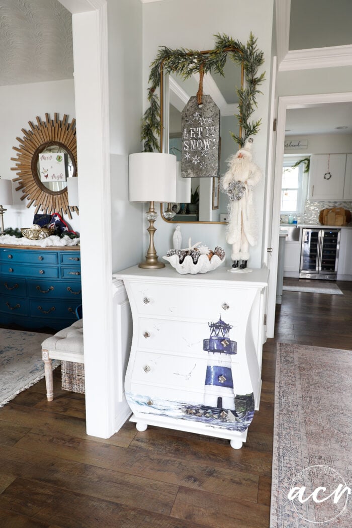 white table with mirror over in foyer