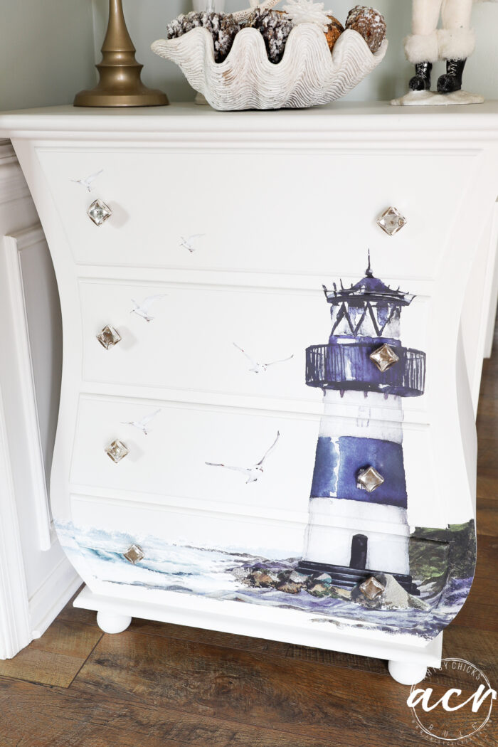 small white curvy chest with lighthouse on front up close
