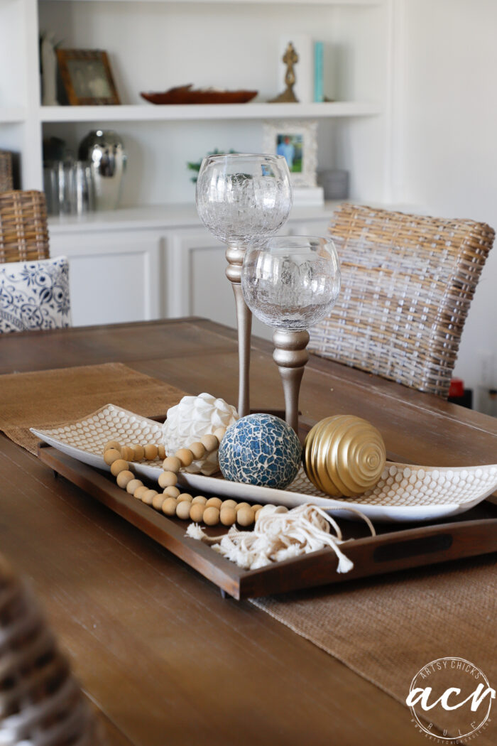 table with tray and decorative spheres and 2 candlesticks
