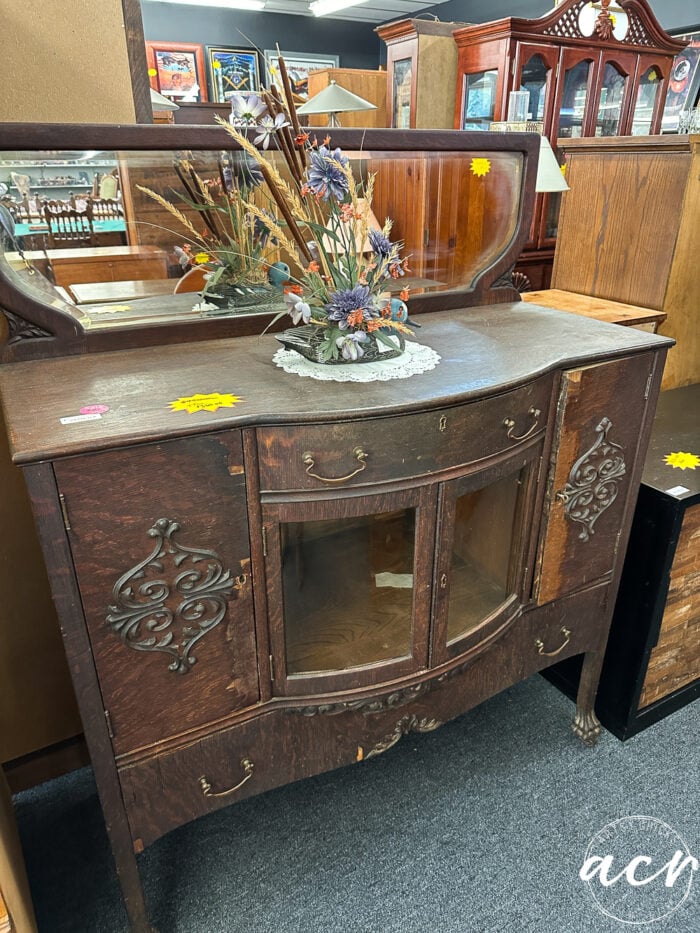 wood sideboard with curved glass doors, ornate carvings and mirror