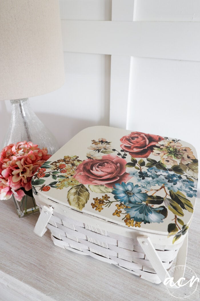 white basket with floral transfer on dresser with lamp