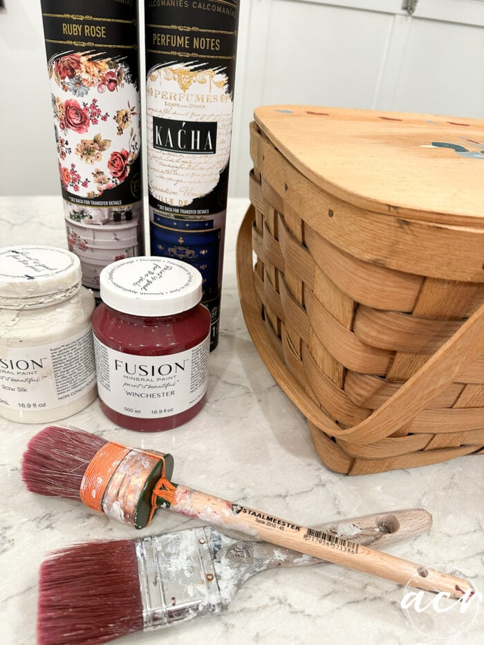 paint, brushes, transfers and basket on counter