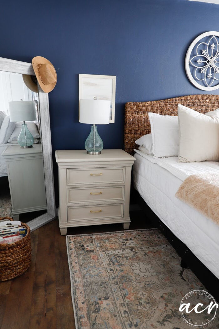 blue wall white bed and nightstand