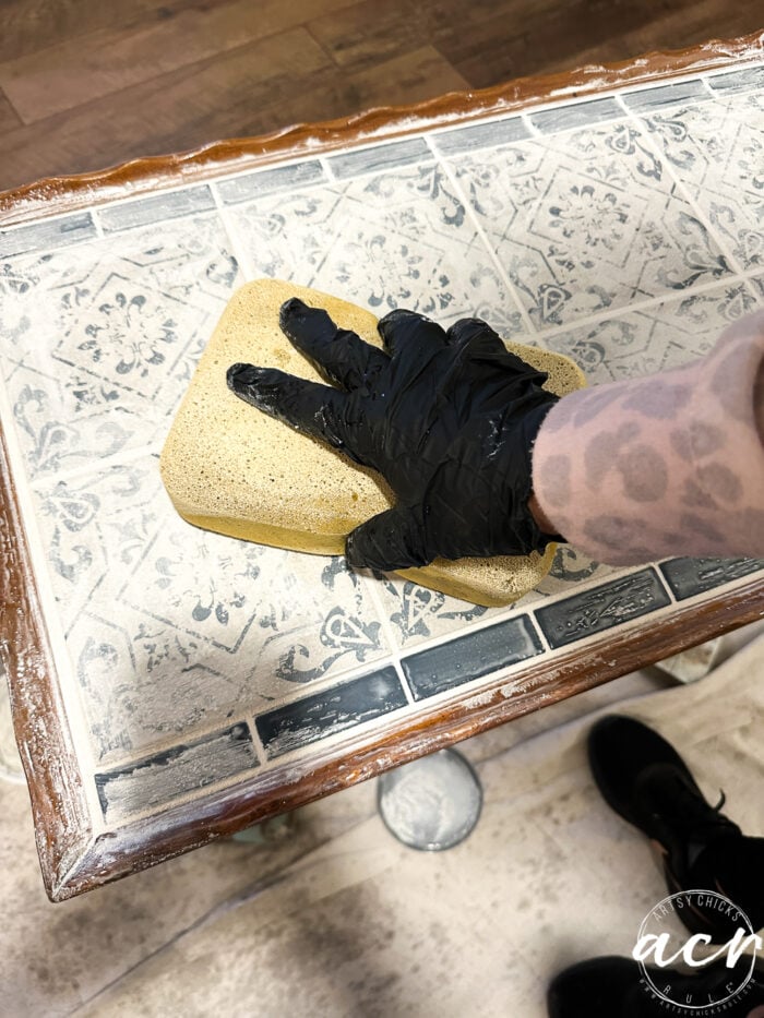 wiping excess grout with sponge