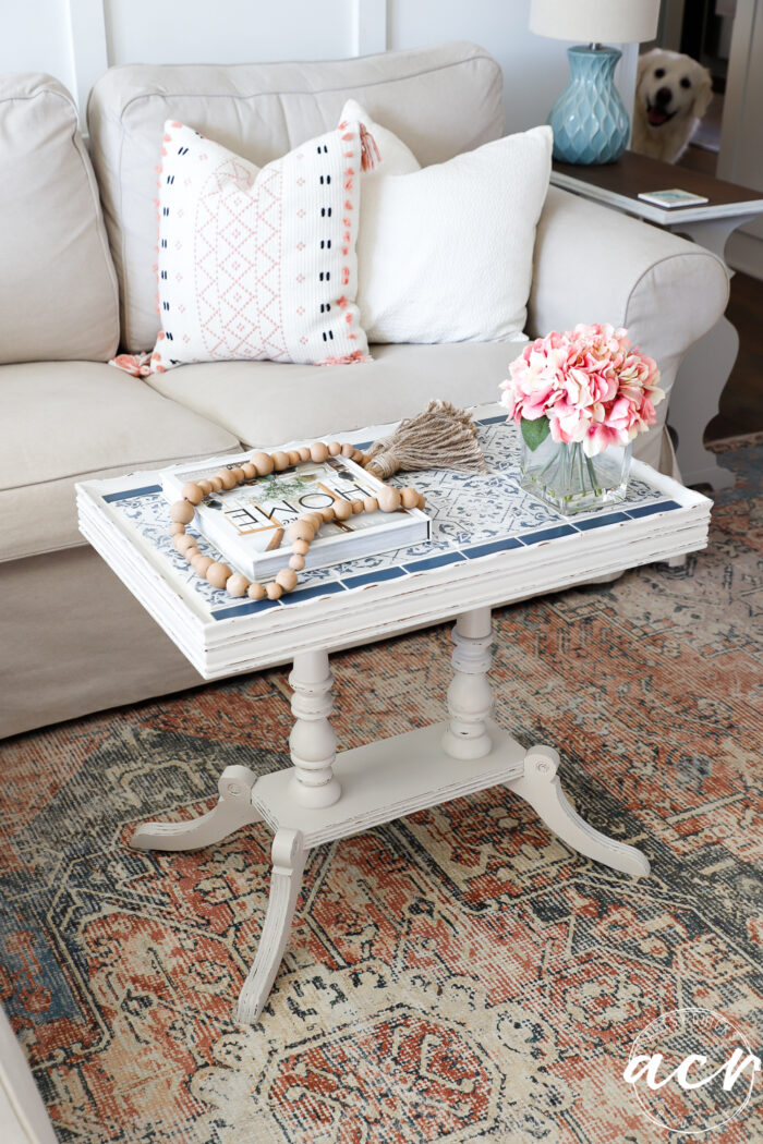 off white table with blue and white tile on top