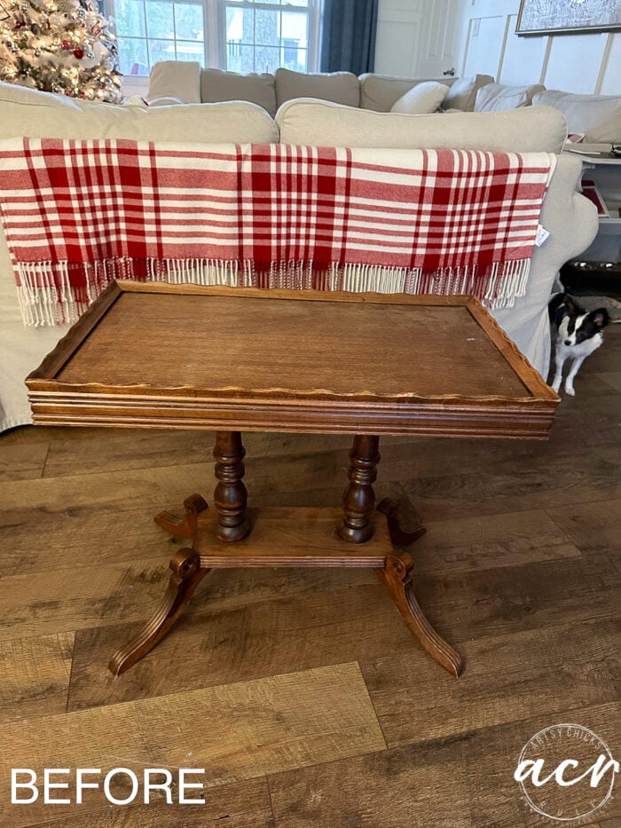 wood stained rectangular table before and tiny black and white dog