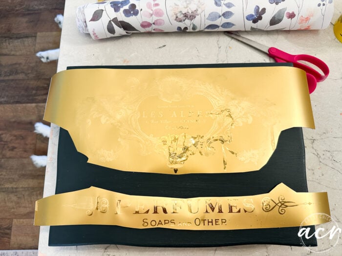 gold transfer cut in two on box and puppy feet