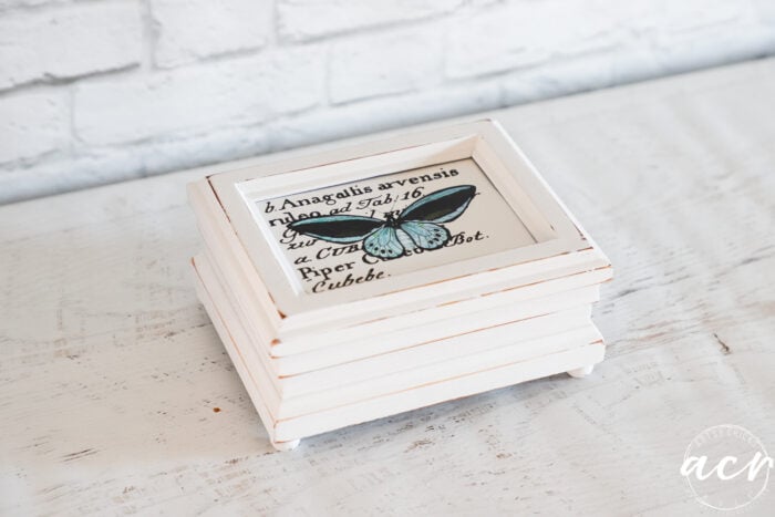 little white box with blue butterfly on top