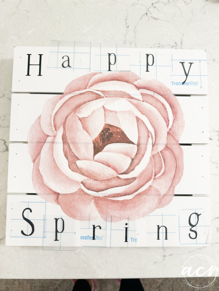 pink flower with happy spring letters