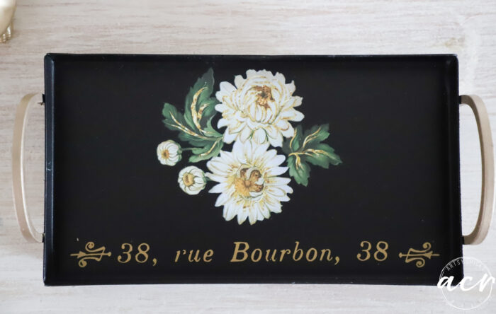 black tray with white florals and gold accents
