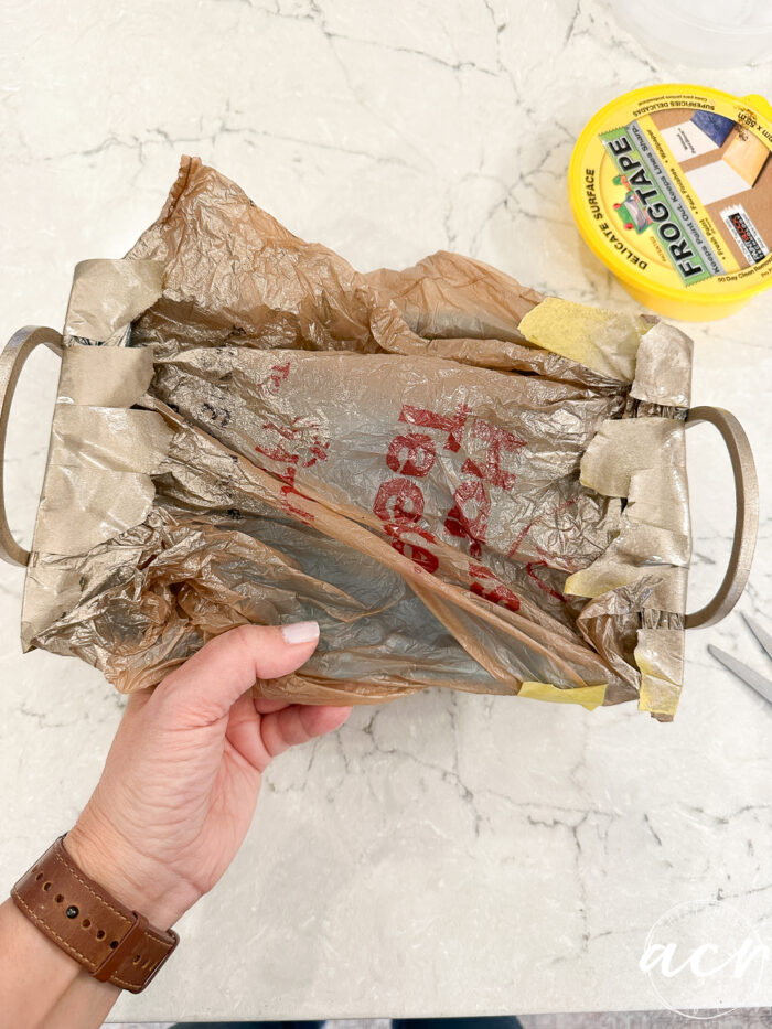 plastic bag covered tray with gold sprayed handles