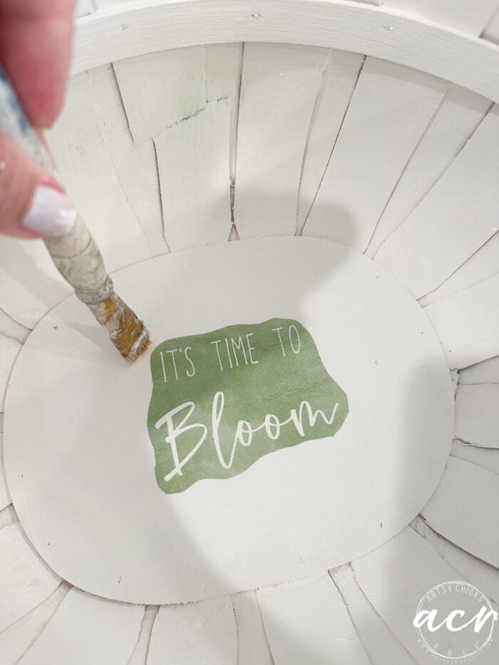 green napkin in bottom of inside of basket