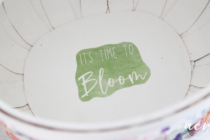 inside of basket with green napkin that says it's time to bloom
