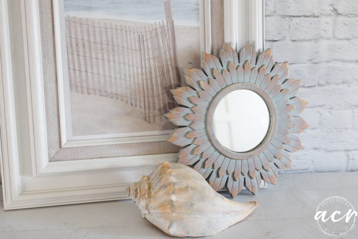 framed print, seashell and small painted mirror