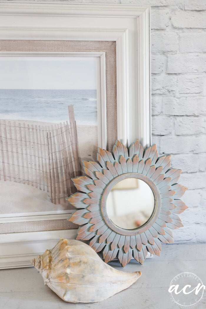 framed print, mirror and seashell