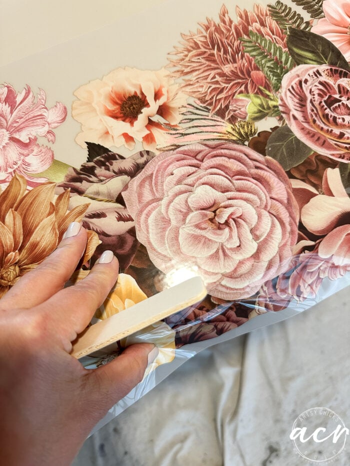 applying the floral transfer to the top of the table