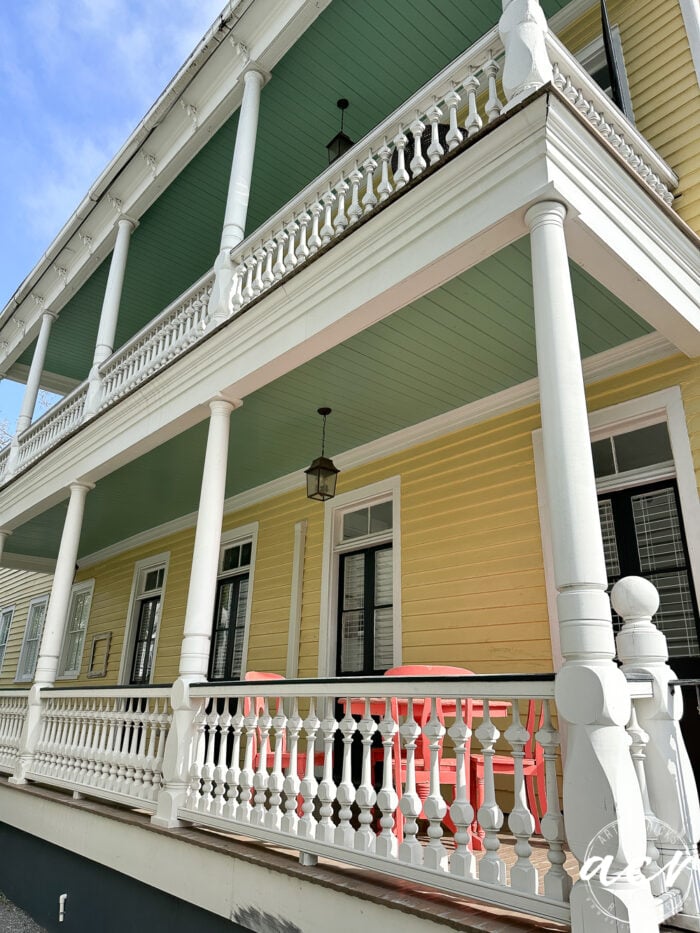 yellow house with side porches with blue ceilings