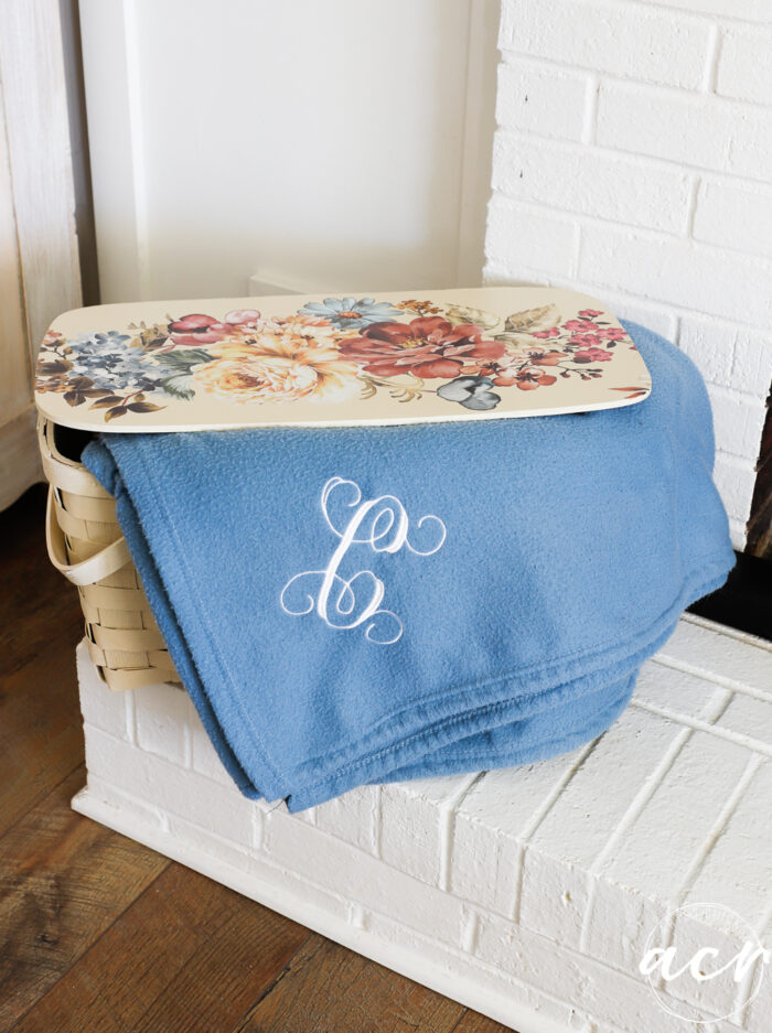 pretty basket on fireplace with blanket