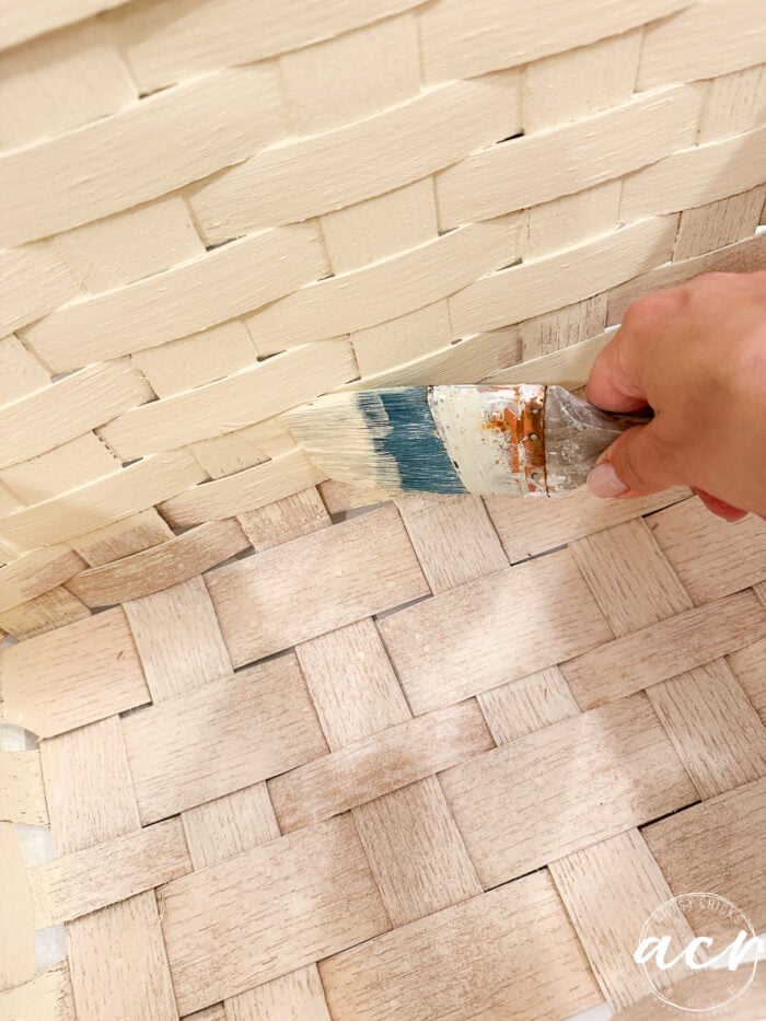 paintbrush with paint on it inside basket
