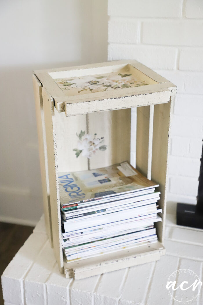 crate on fireplace with magazines