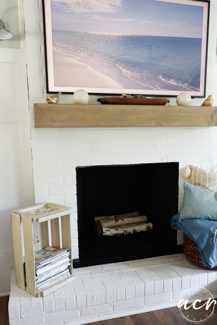 crate with magazines on fireplace with Frame TV