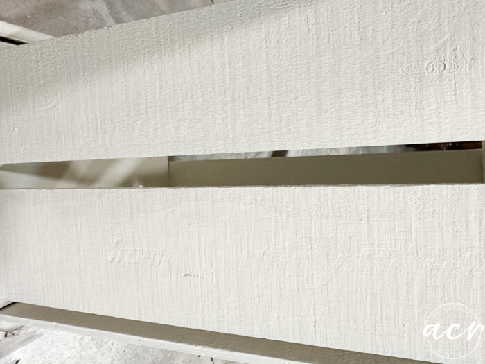 two coats of paint on side of crate