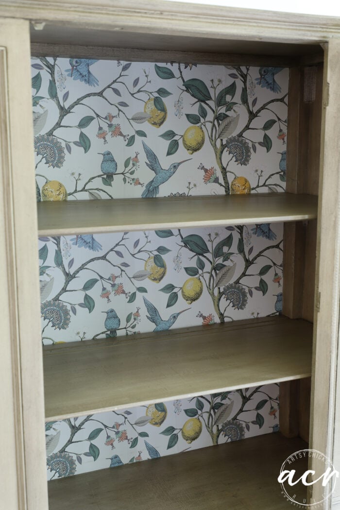 up close of inside of cabinet with wallpaper