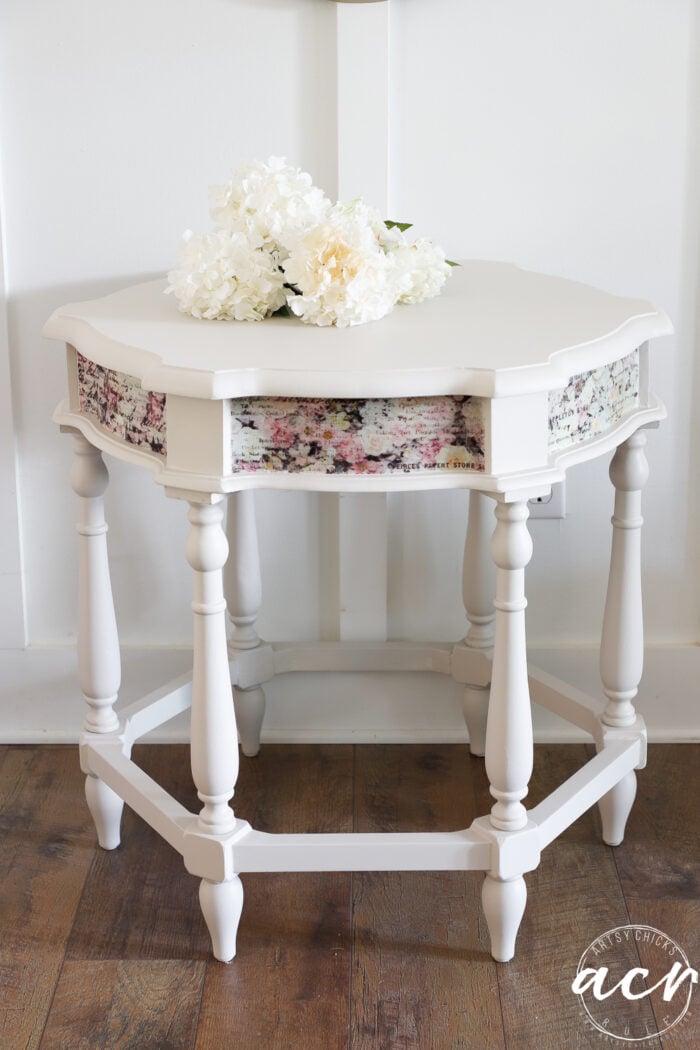 painted table with white flowers laying on top