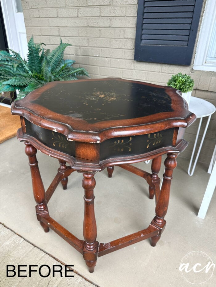 dark stained table with black decorative inset design