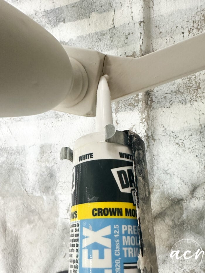 applying caulk to crack