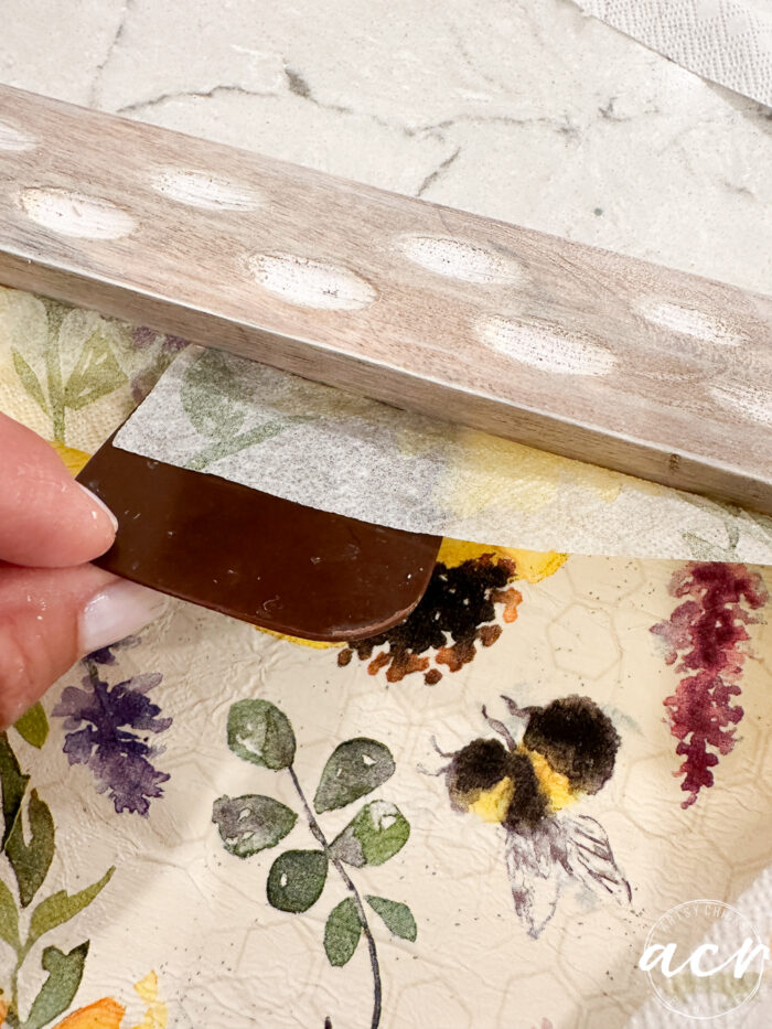 scraper pressing napkin into corners