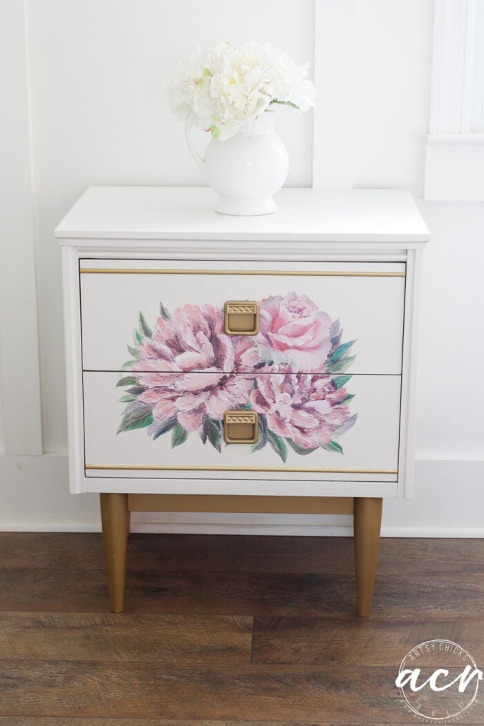 white nightstand with gold trim and pink transfer