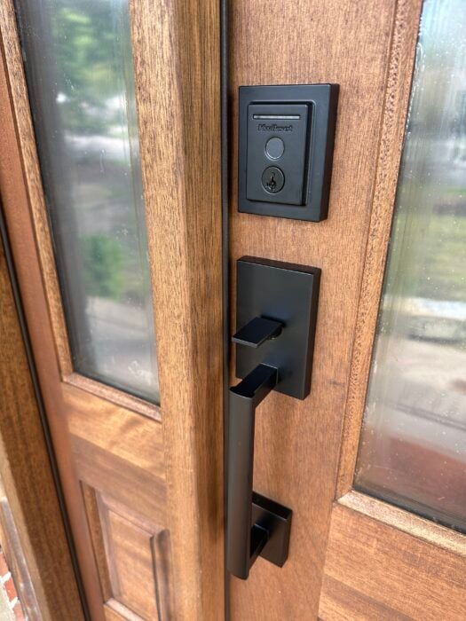 wood front door with black handle