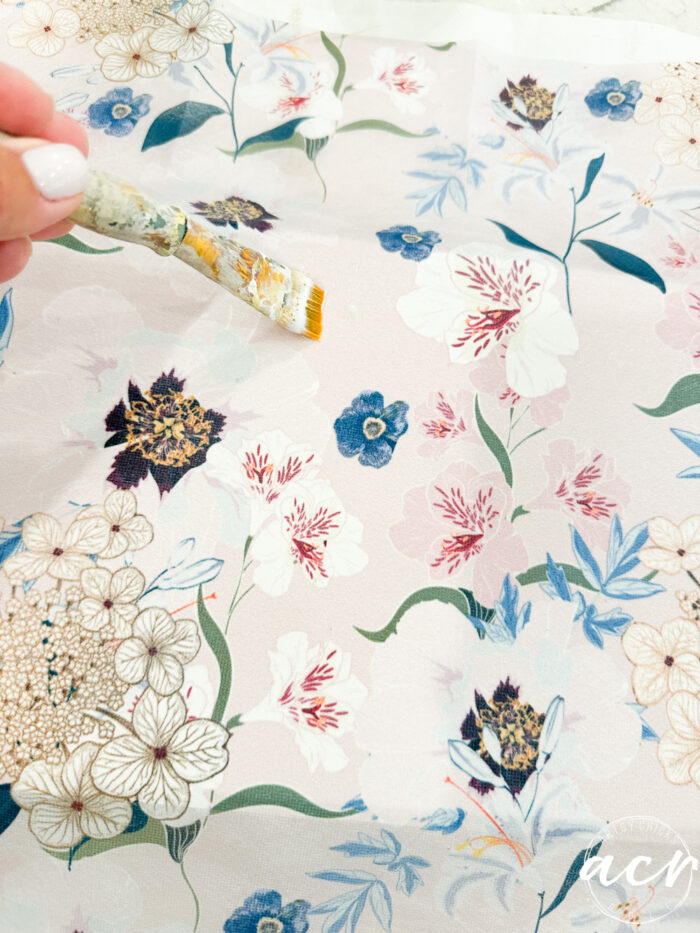 applying the decoupage gel on the top of the tissue paper too