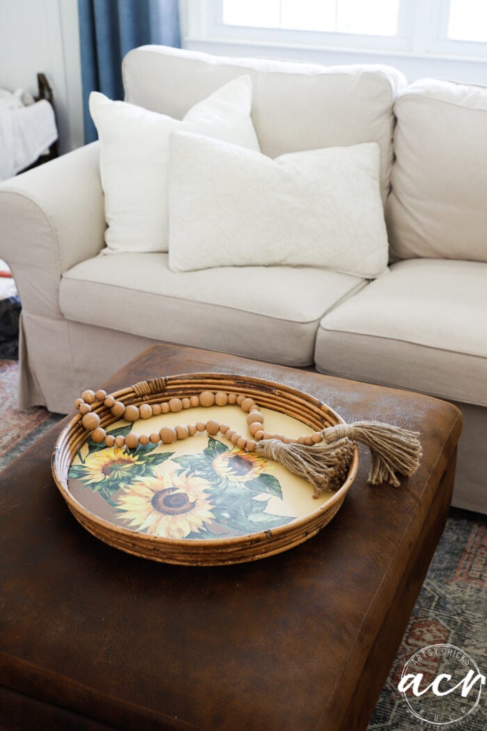 sunflower tray on ottoman with couch behind