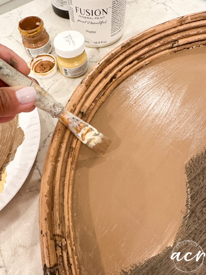 painting tray on one side with brown color