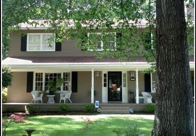 tan with white trim and black shutters, with white home