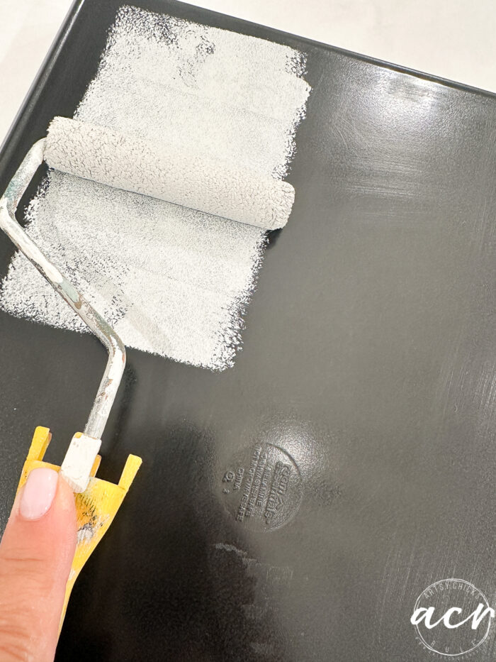 rolling the paint onto the tray over the ultra grip that has dried