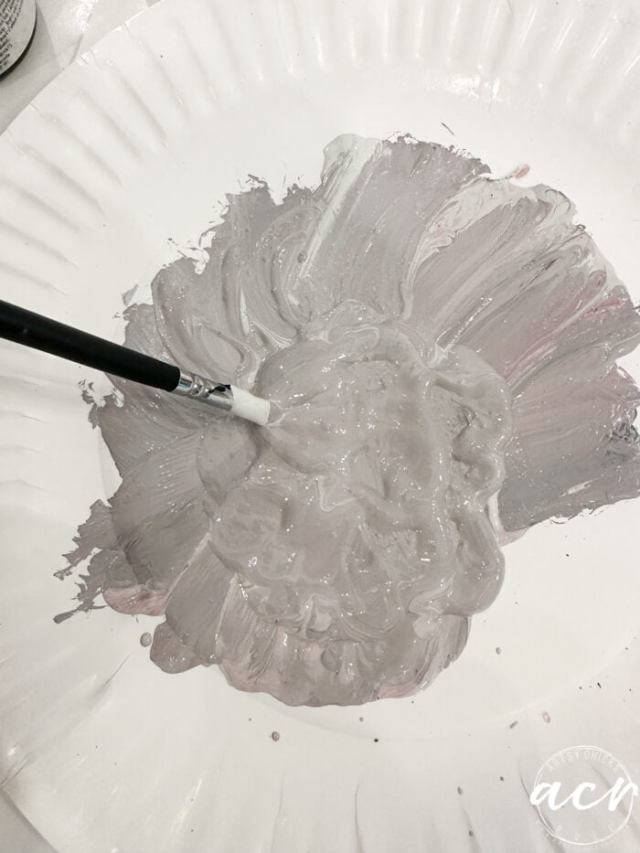 paper plate with mixed paint and small brush