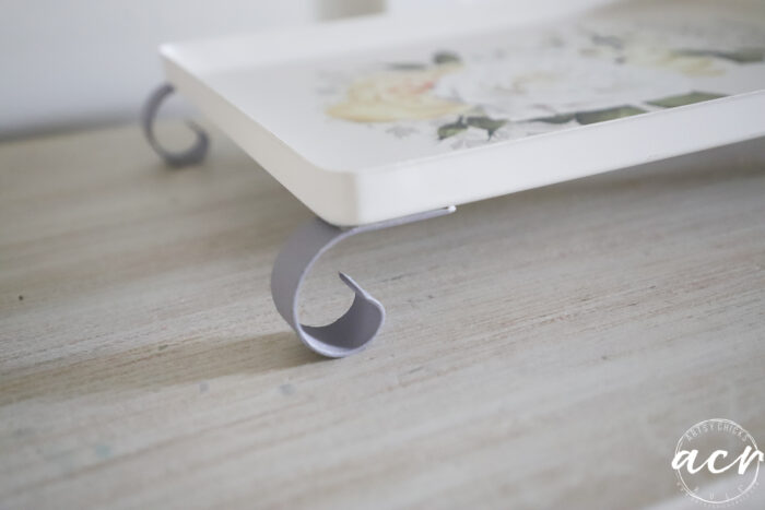 side view of white tray with curved gray/purple feet