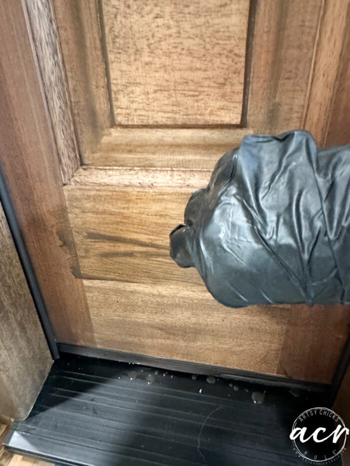 applying stain to wood door 
