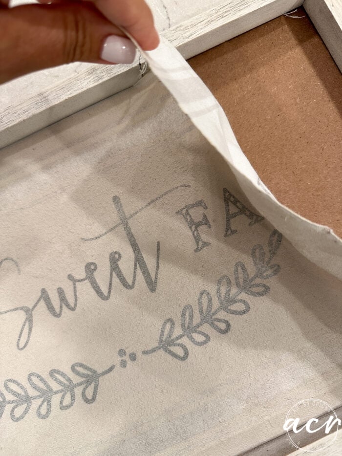 removing the fabric with fall sign printed on it