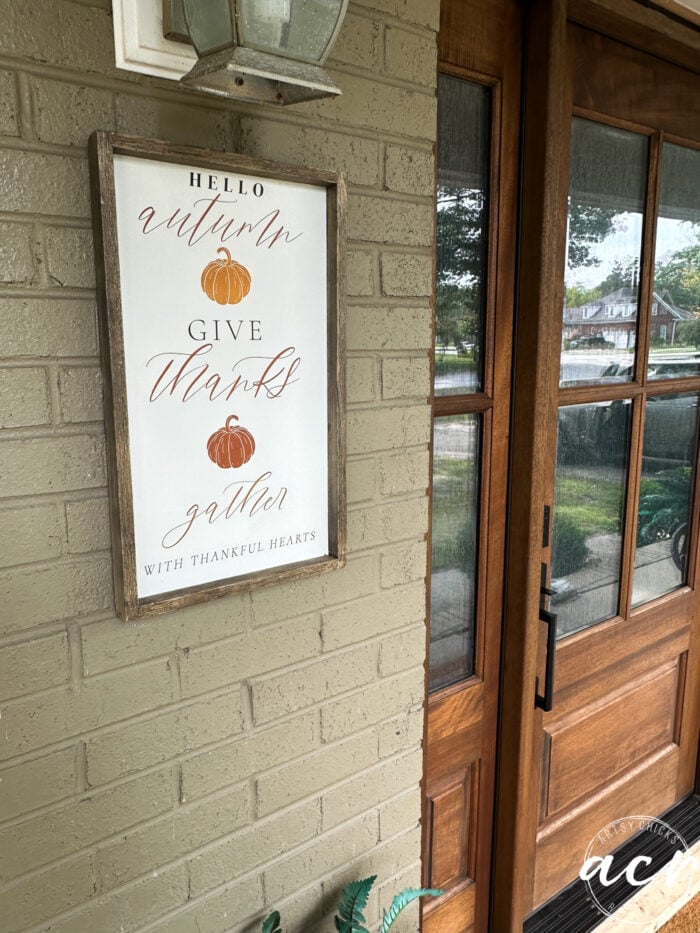 fall sign on brick front wall of house