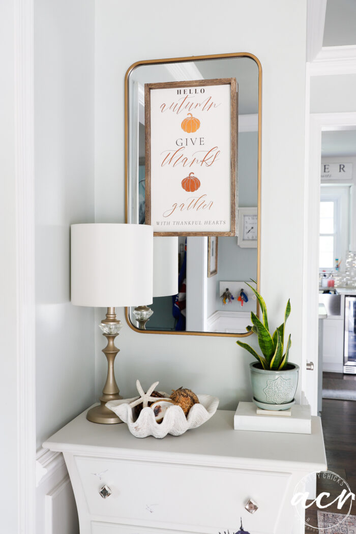 fall sign on mirror over chest in foyer