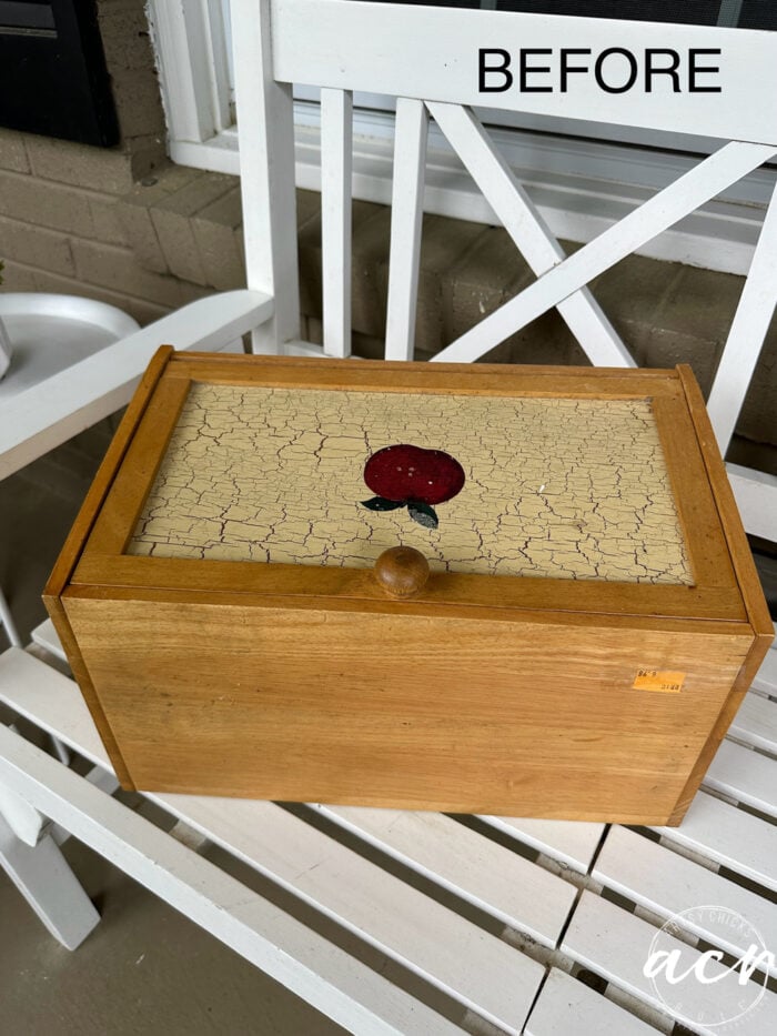 orangy wood bread box with apple on front